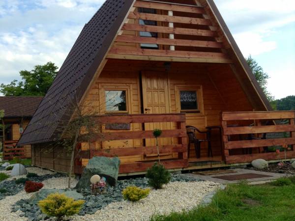 Domek A. Na dole salonik z TV, aneks kuchenny, łazienka z prysznicem. Na górze dwa osobne pokoje w każdym po dwa pojedyncze tapczany.