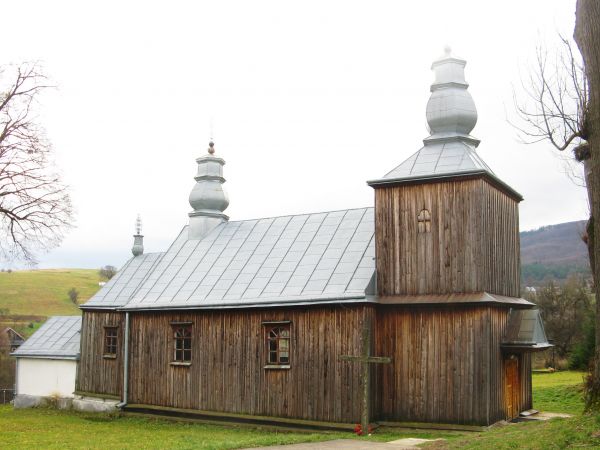 na świątyni, zewnątrz, dołem : fartuch z blachy - kryje i zabezpiecza podmurówkę świątyni,  nad głównym wejściem nadwieszony daszek dwuspadowy, kryty blachą.