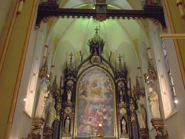 we wnętrzu świątyni z białymi ścianami : stylowy, czarny ołtarz główny, w oknach umieszczono kolorowe witraże ufundowane w większości przez bpa Pelczara, przeds