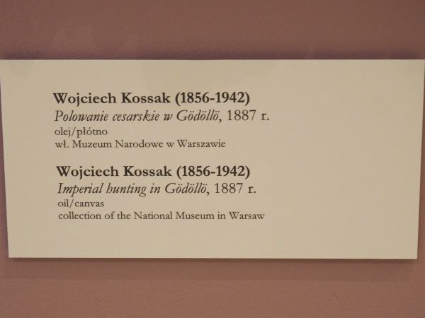 tabliczka pod obrazem ze sceną z polowania.