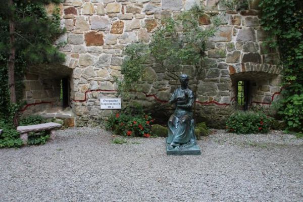 pani na zamku - tuli pieska, może na bramę zamkową spogląda i powrotu męża oczekuje bo napastników pogonił - opryszków, co na szlaku handlowym kupców napadali ?