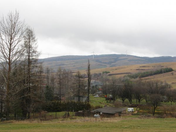 zalesione grzbiety górskie - to pasmo "Moczywa" się nazywa a szczyt tam  najwyższy to Debry - 576m npm, poniżej ściany lasu : turbiny wiatrowe.