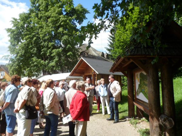 początkowy etap zwiedzania skansenu - n/z przewodnik przy planszy z mapą terenu i rozmieszczonych tam obiektach.