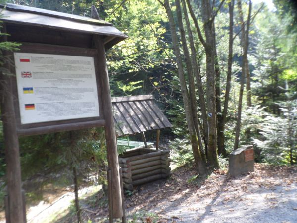 tablica czerwona na kamieniu wskazuje na Rezerwat geologiczny "Gołoborze"  i tam przez mostek możemy wędrować, tu zaś studnia - pozorna - udawana a po to by wie