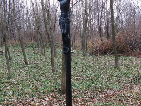 krzyż metalowy osadzony w "lanym kamieniu" i ustawiony na płycie nagrobka cmentarnego, teren uprzątnięty i ubogacony staraniem Stowarzyszenia "Dziedzictwo Mniej